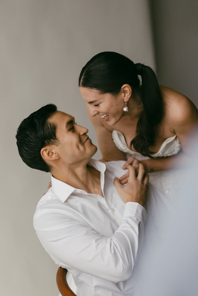 bride and groom look into each other's eyes smiling